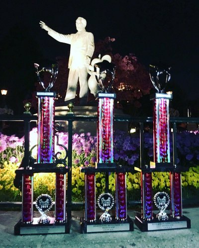 A statue of Walt Disney oversees the trophies the Lemoore High School choir program earned Saturday at the Music in the Parks Festival.